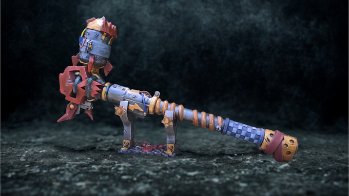 A colorful and intricate mechanical object resembling a weapon or tool, with various mechanical components and a striking design.
