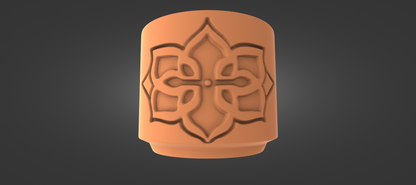 An orange ceramic object with an intricate floral design on it.