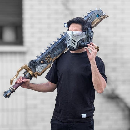 A person wearing a black t-shirt and holding a large, ornate sword-like weapon.