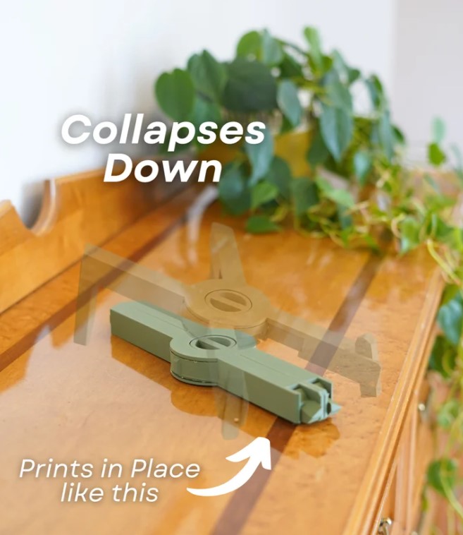 a wooden dresser with a plant on top, and there is a green tool or device on the dresser.