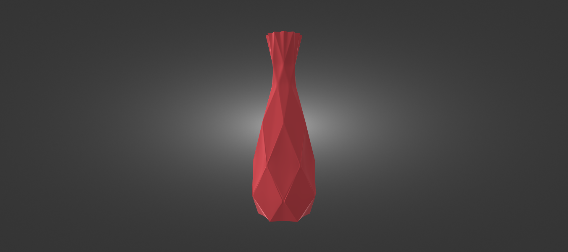 A red, geometric vase stands alone against a dark background.