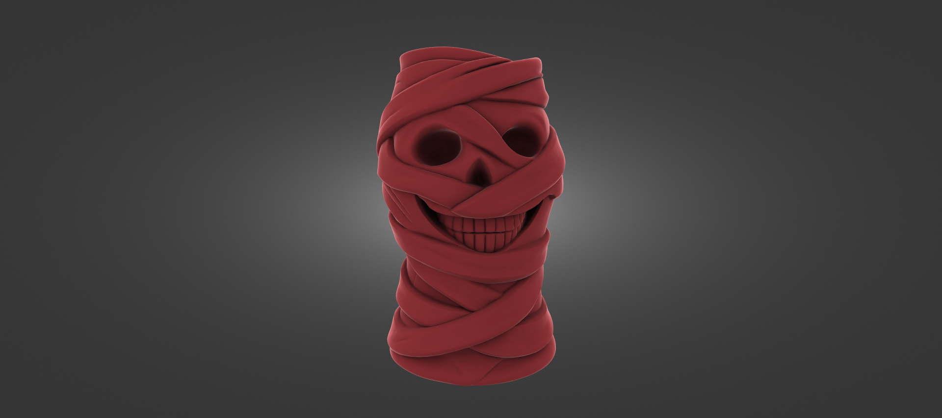 A red, twisted, and coiled object resembling a skull or a similar shape, with a smiling expression.