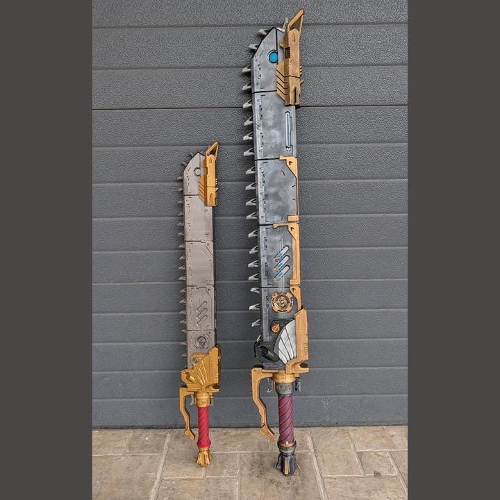 Two large, futuristic-looking swords stand against a gray wall.