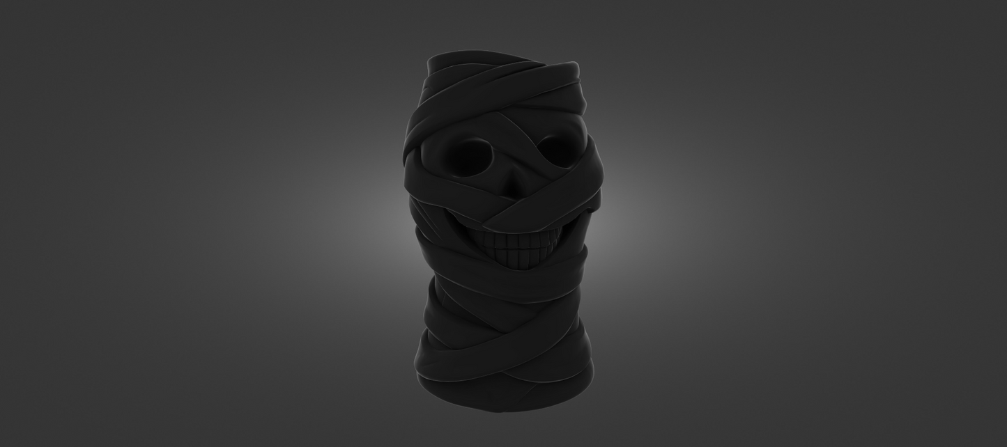 A dark, abstract sculpture resembling a skull or a mummified figure, with a twisted, coiled shape and a dark, shadowy appearance.