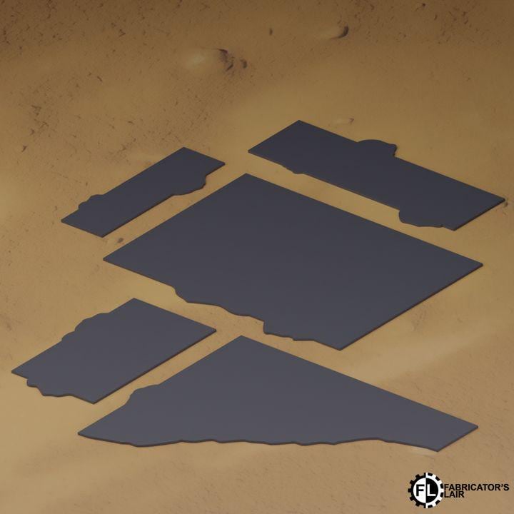 several dark blue rectangular shapes arranged in a pattern on a sandy surface.
