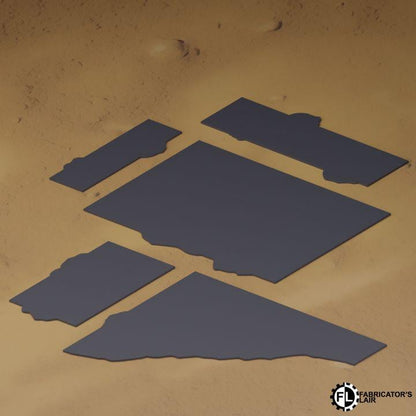several dark blue rectangular shapes arranged in a pattern on a sandy surface.
