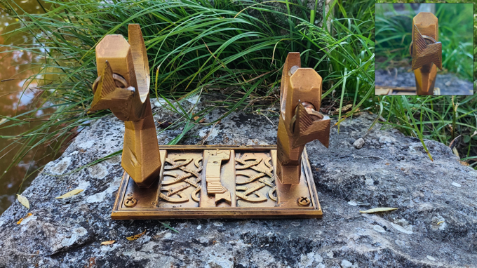 a pair of wooden objects, possibly a pair of scissors or a similar cutting tool, placed on a rock. The objects appear to be carved and have a distinct design.