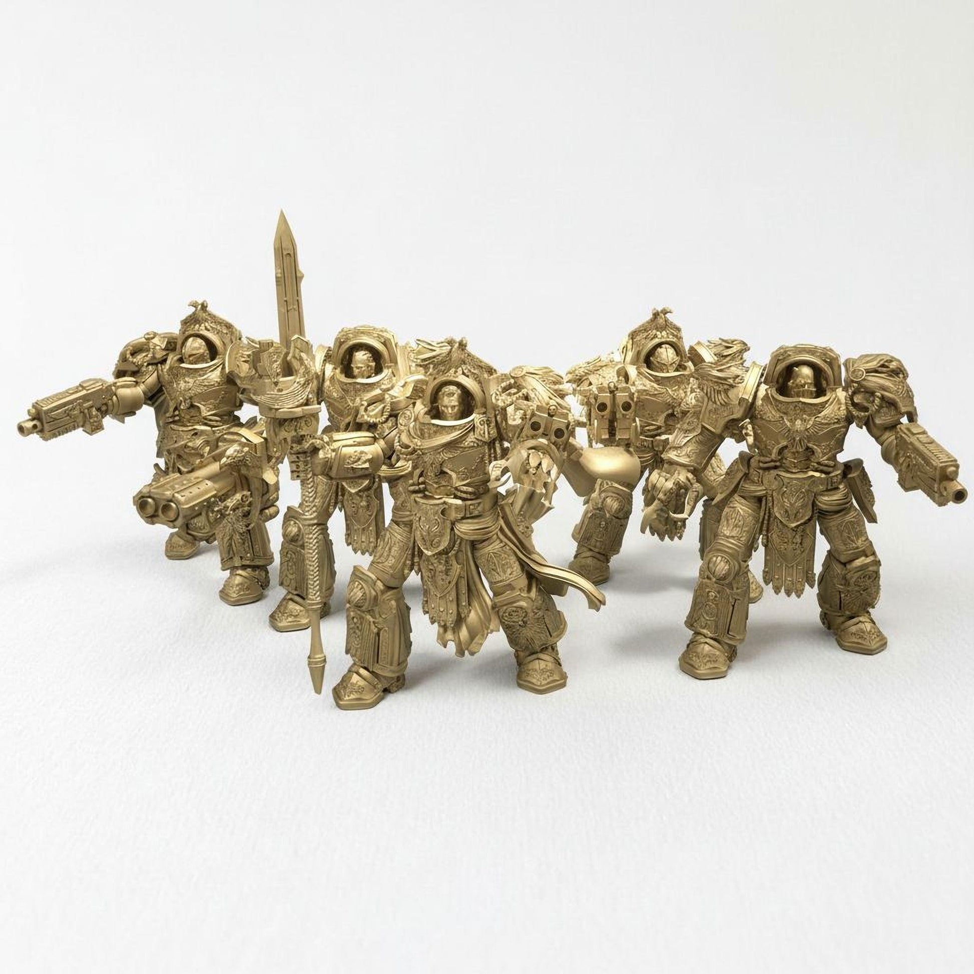 A group of golden-colored figurines of soldiers or fantasy characters, arranged in a row and facing the same direction.