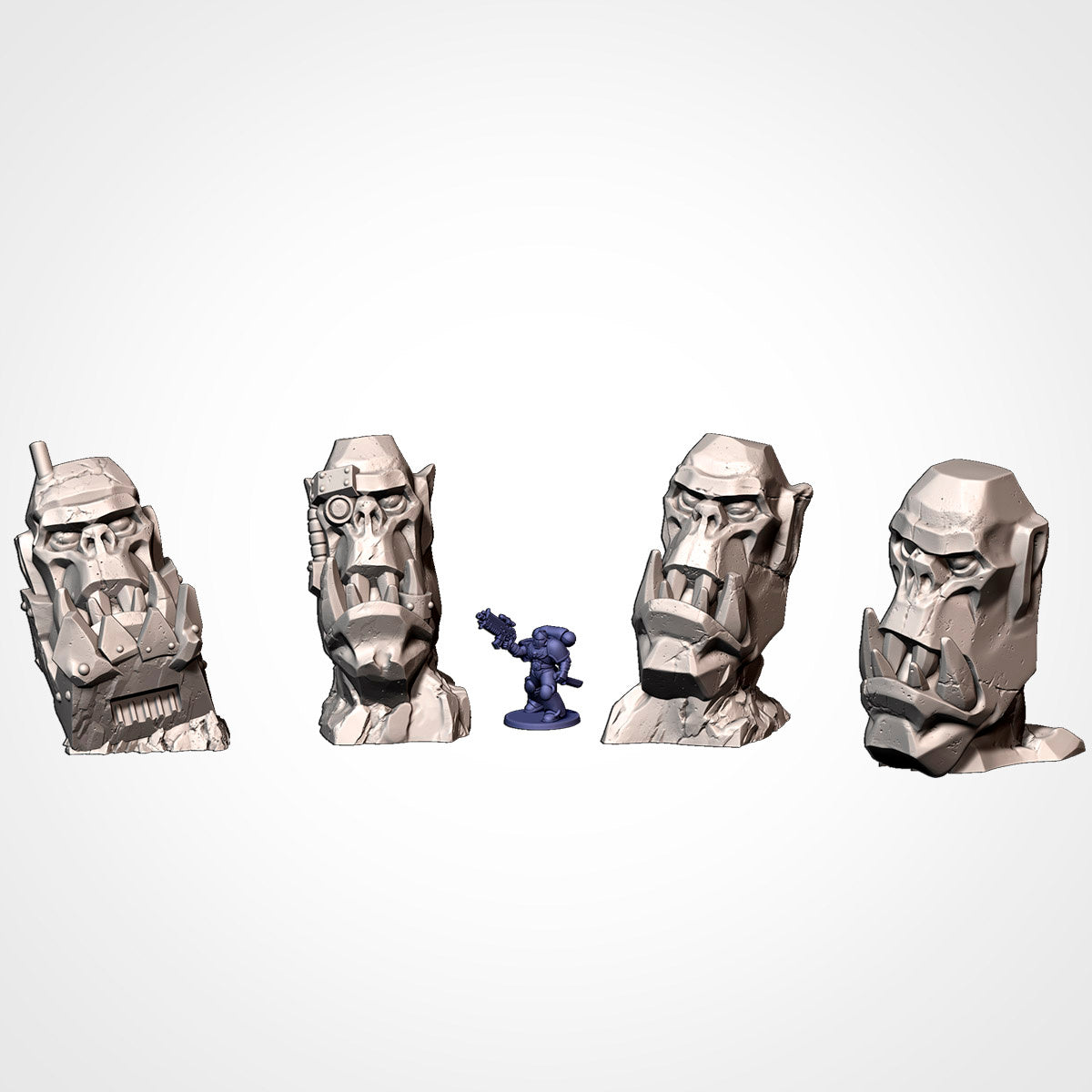 Four distinct Ork head scatter terrain monuments with miniature for scale